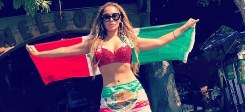 A woman in a bikini holding an italian flag.